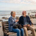elderly couple sitting on a bench in cape town discussing retirment options