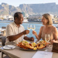 a couple at a ish restaurant troasting a well planned retirement