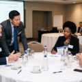 fund managers discussing pension fund fee structures at a lunch