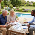 couple sitting on their patio with awealth manager discussing compulsory annuitization